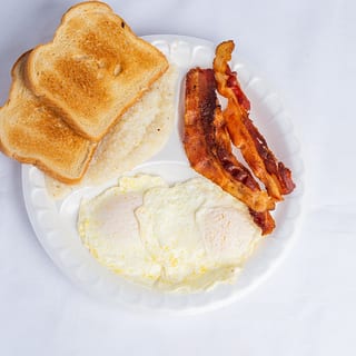 2) Xl Eggs, Grits ,Toast, Choice Of Meat